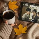 Cozy fall setting with K-drama on tablet, warm drink, and blanket