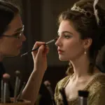 Makeup artist transforming actress for period drama scene