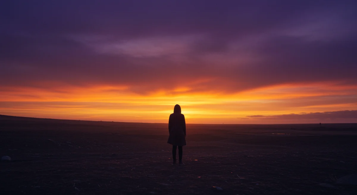 Character standing alone in melancholic landscape, deep in thought.