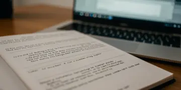Script page with revisions and a laptop, symbolizing the rewriting process in mini-series production.